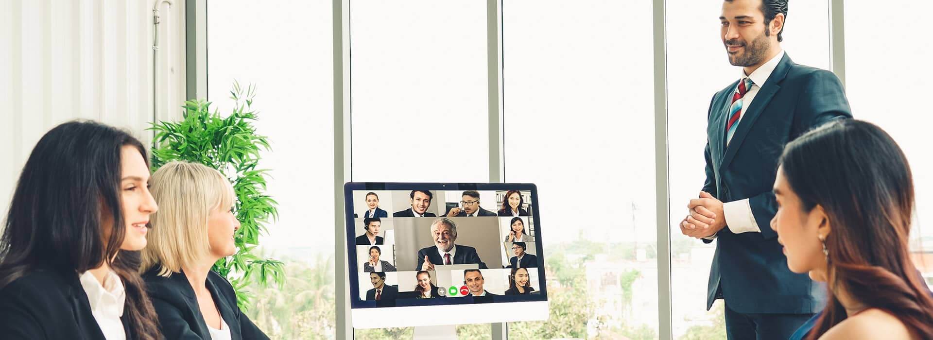 Employees video interviewing a candidate 