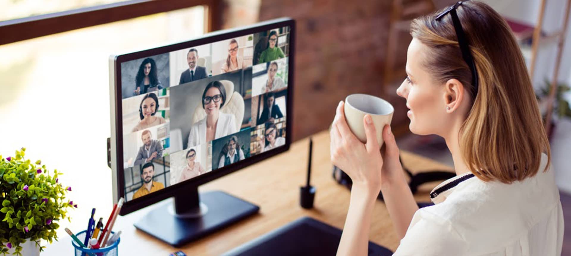 5 Amazing Ways to Get Ready for a Remote Recruitment Market Bounce Back | Elevatus A female recruiter drinking coffee and watching video assessment interviews