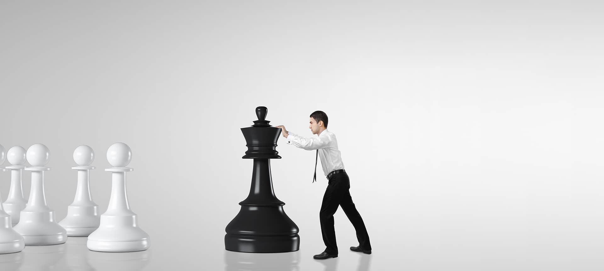 An employee pushing a huge chess piece, symbolizing trying to avoid a failing assessment process.