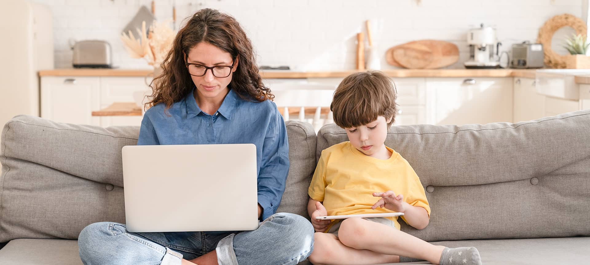 A female recruiter working from home with her son. 