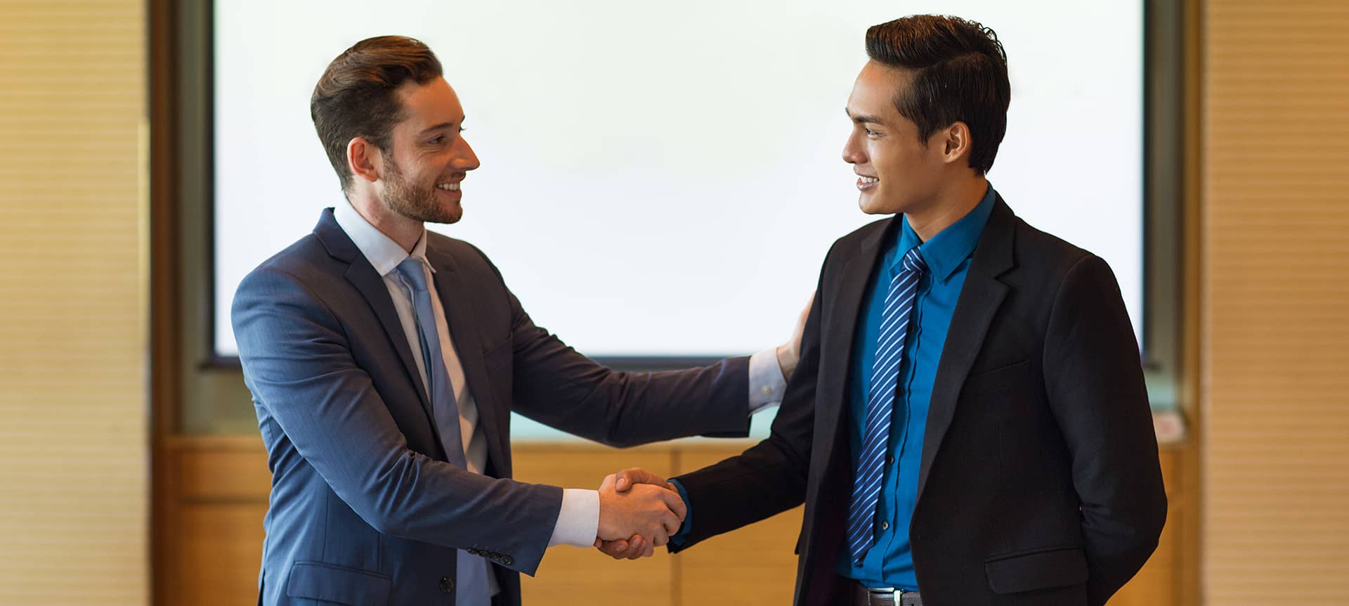 a talent acquisition manager handshaking a cadidate