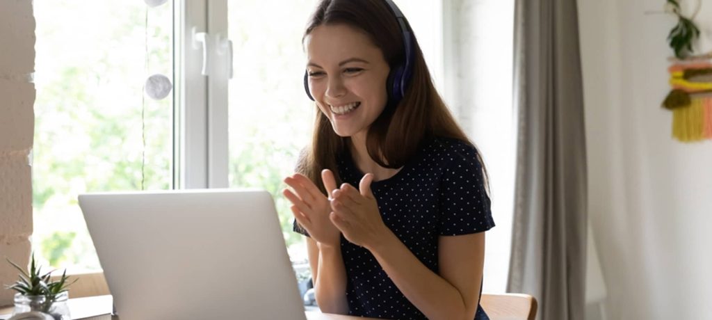 A female candidate laughing after reading about the salary the company is willing to pay for the service of a copywriter
