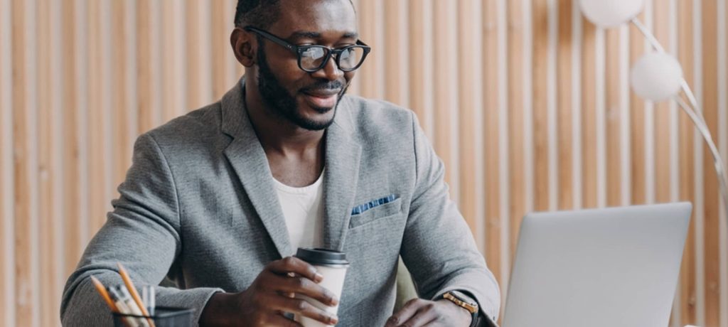 A male HR manager on glass working on Laptop