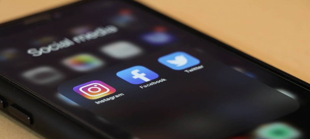 A phone screen showing social apps that can be used to social media recruiting 