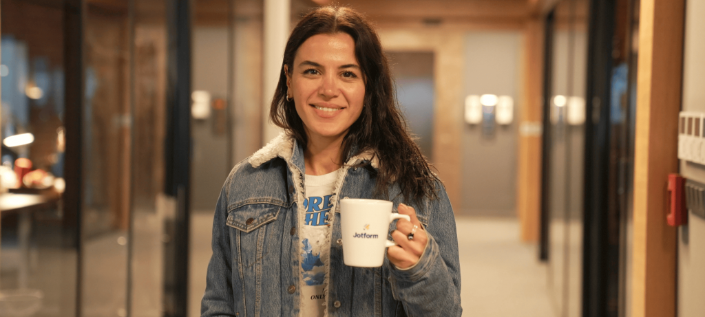 smiling girl holding a cup in her hand