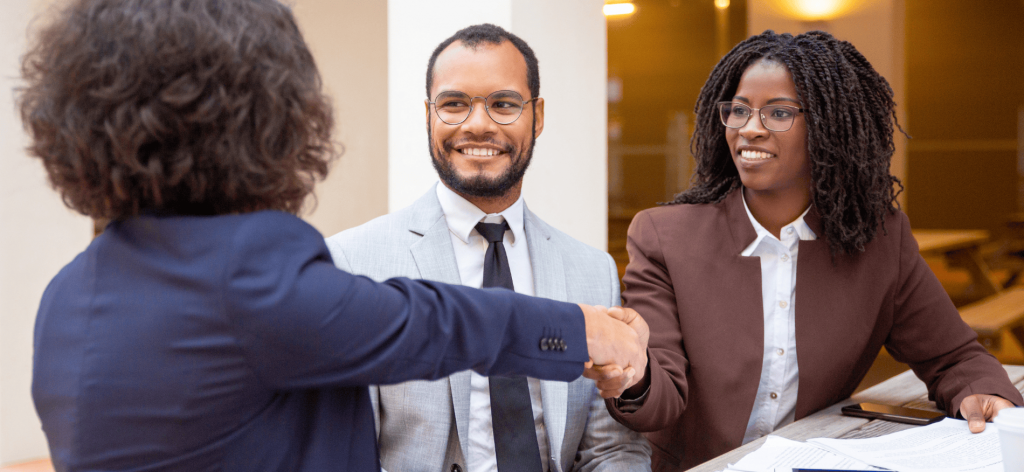 An image of an HR manager welcoming new employees
