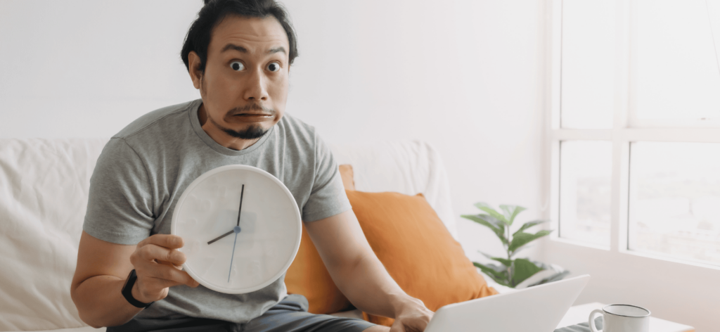 An image of a WFH employee holding a clock 