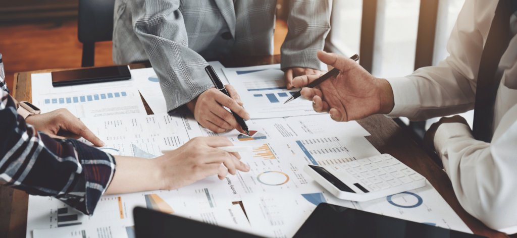 Strategic Hiring: Do You Know Your Real Recruiting Needs? | Elevatus A group of HR professionals discussing a strategic hiring plan during a meeting.