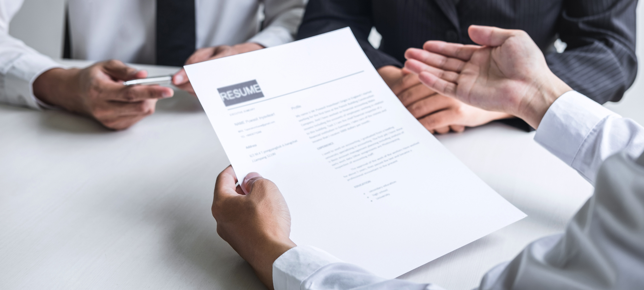 HR employee reads a cover Letter to hire top talent