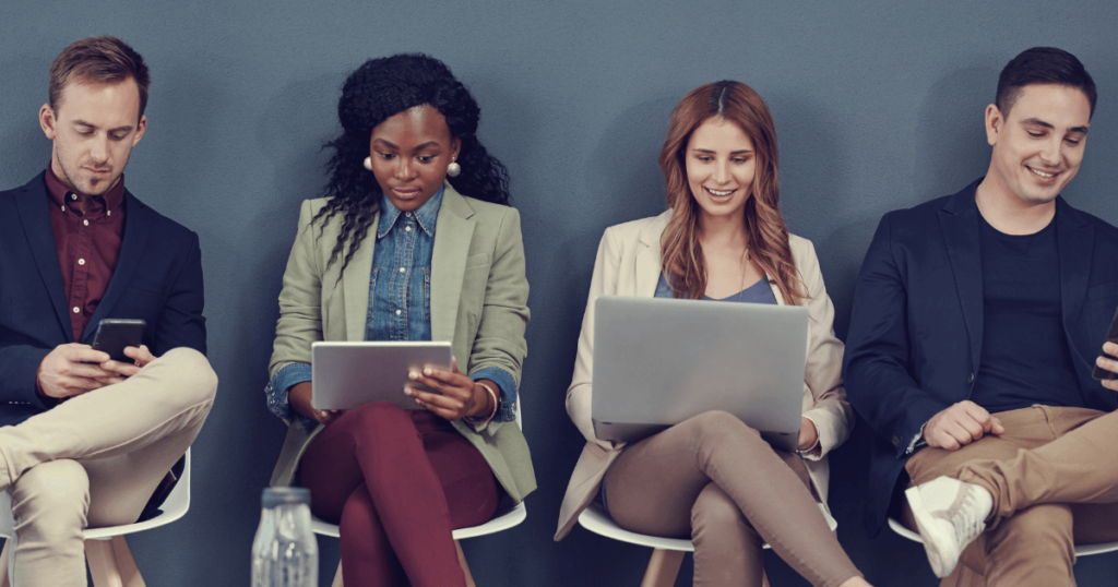 An image of job candidates in Saudi Arabia preparing resumes and applying online.
