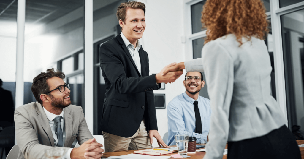 An image of a recruitment team collaborating with the help of HR recruiting software.

