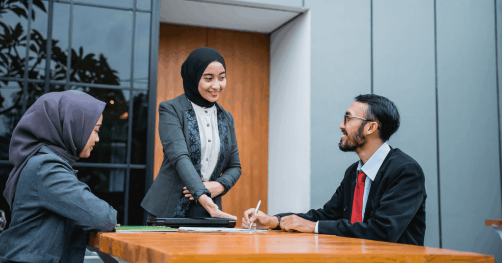Colleagues in Qatar discussing internal transfer interview questions during a meeting

