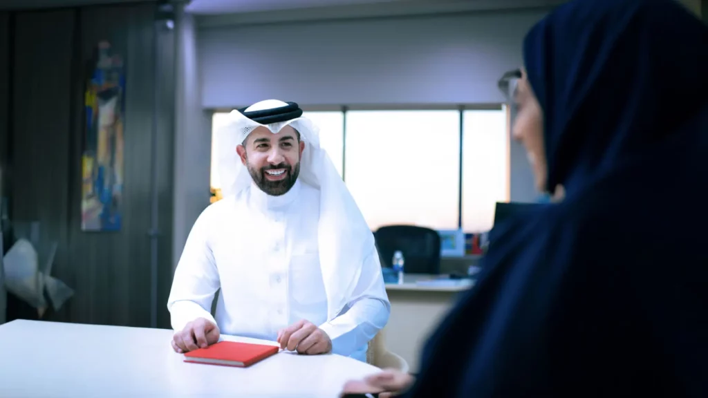 An image of an overwhelmed HR manager surrounded by paperwork while trying to complete tamkeen hiring documentation