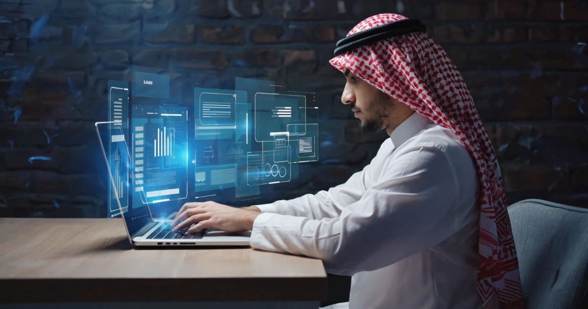 An image of Saudi HR professionals in traditional attire reviewing colorful personality tests results on a large office screen.