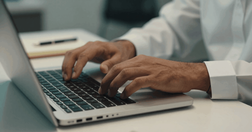 An image of a laptop and notebook arranged for a no-show interview follow-up email