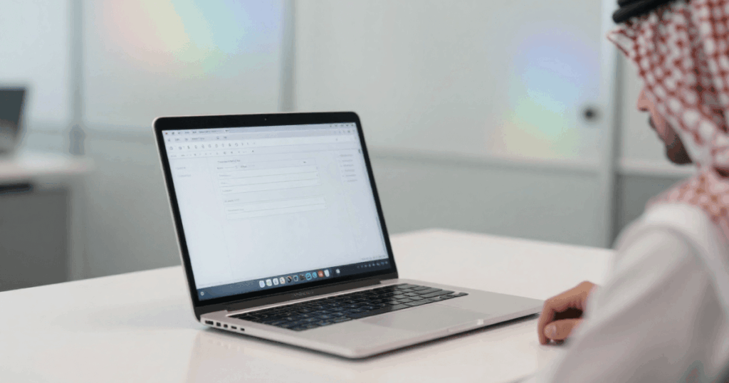 An image of a recruiter using laptop for employee onboarding software